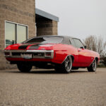 A photo of a 1970's Chevelle in nice condition, red with black trim.